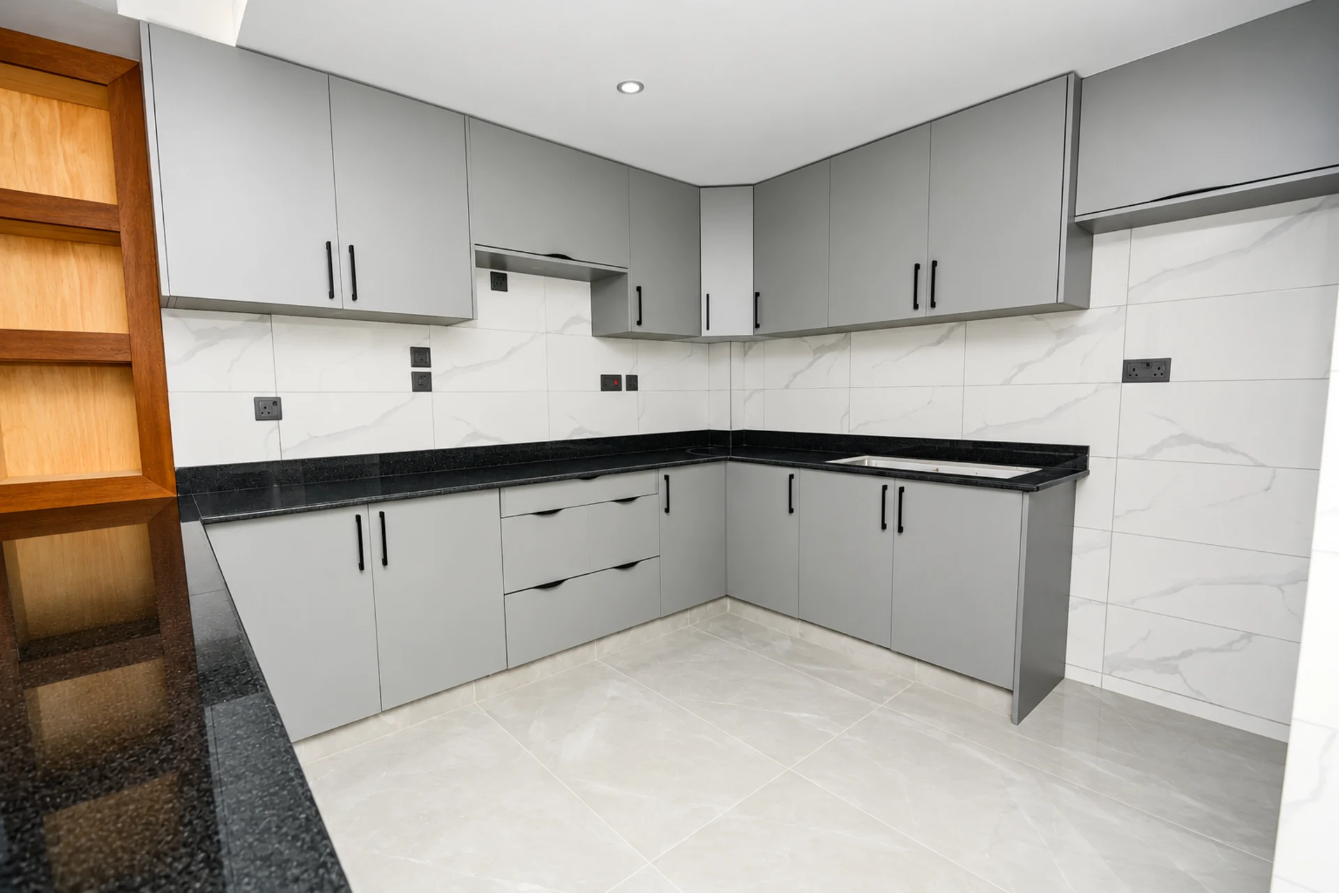 Grey fitted kitchen cabinets with a granite worktop