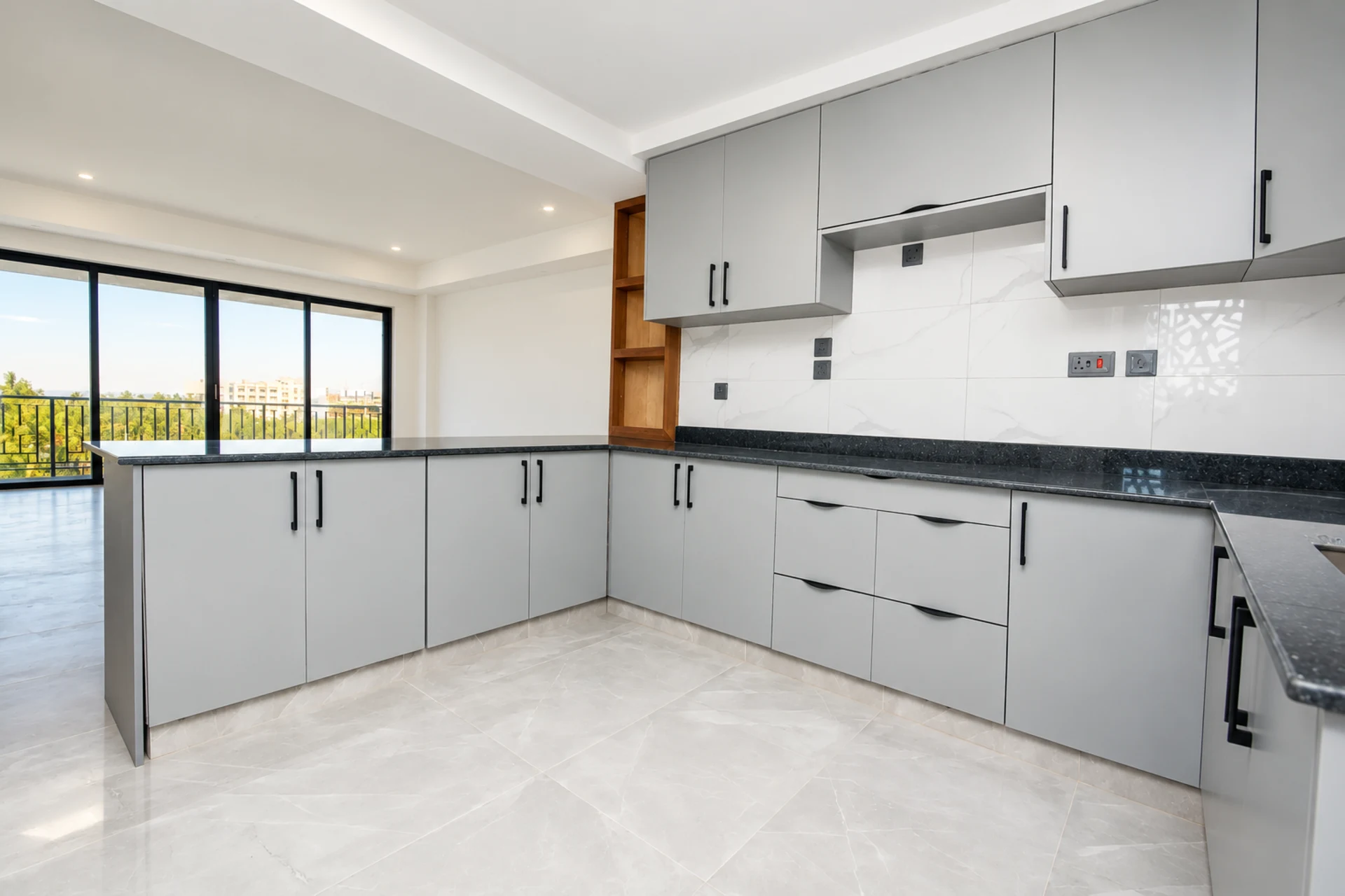 An L-shaped kitchen open to the living area and its windows