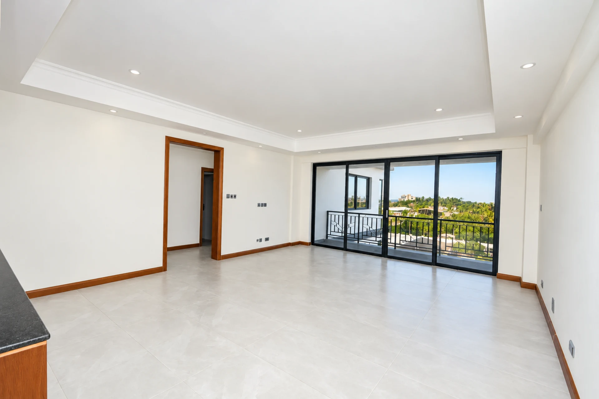 A bright living room with sliding doors to the balcony