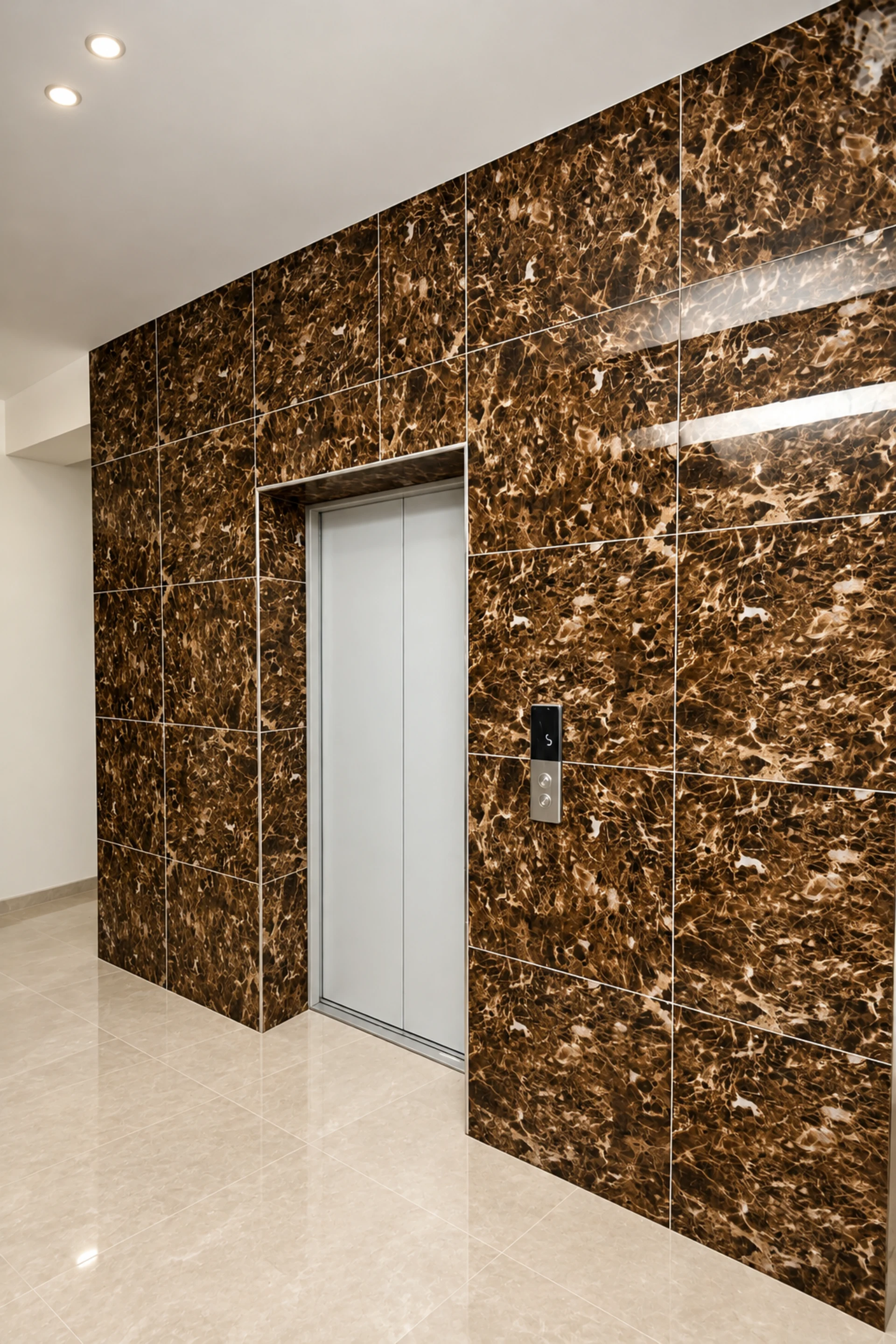 The lift lobby, lined in dark marble