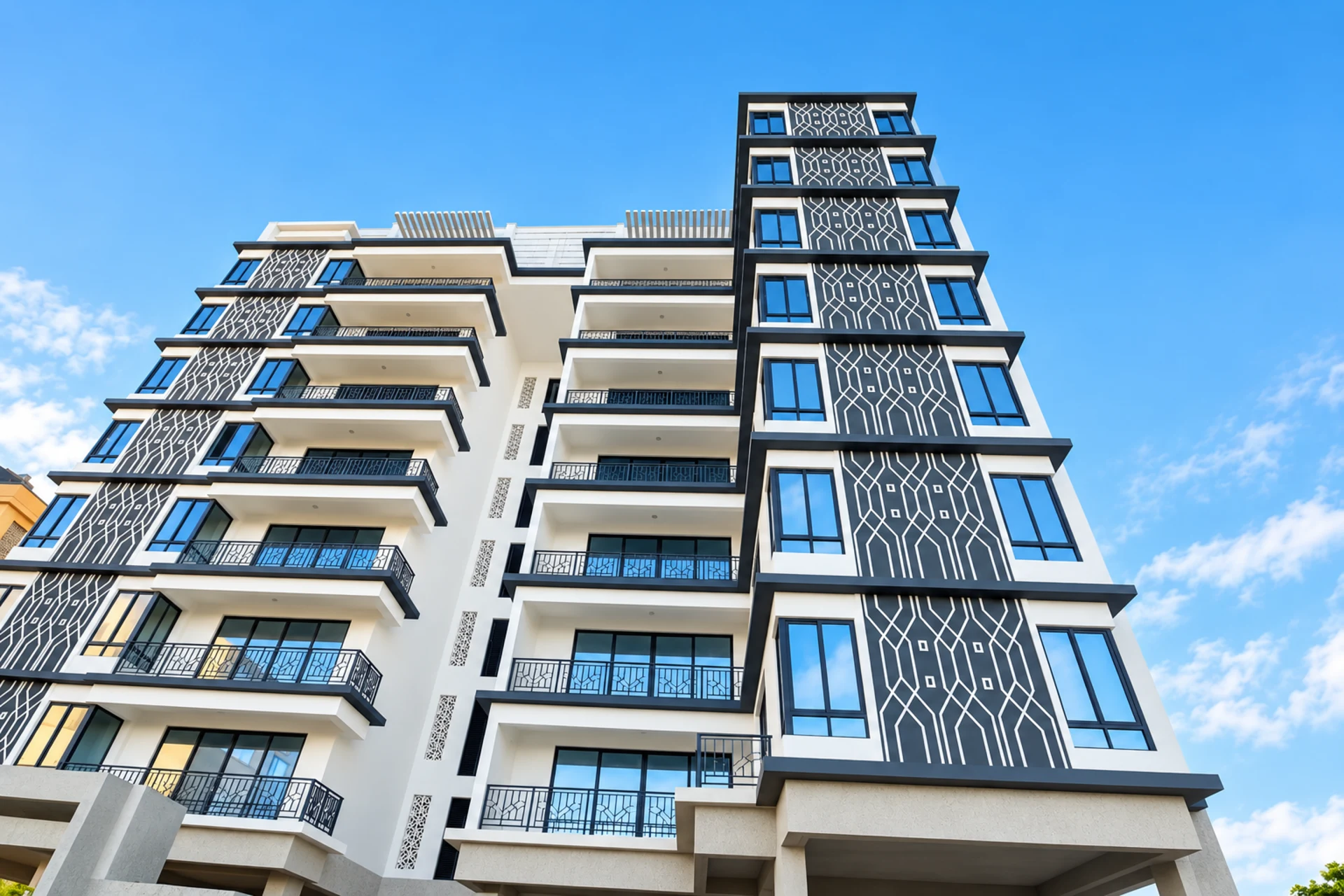 Premier Sea View Apartments from street level: a white tower with charcoal lattice panels and glass balconies