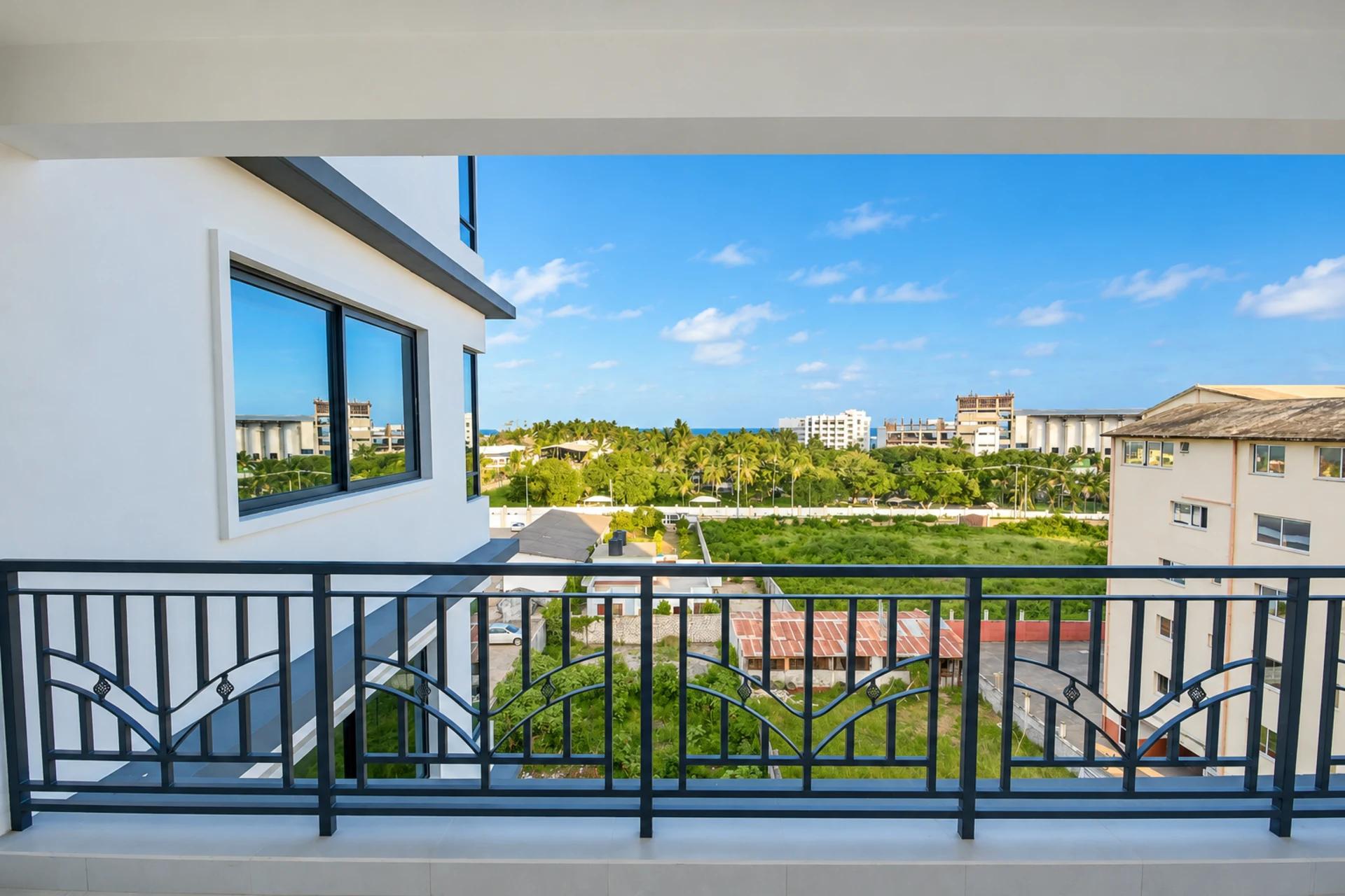 The view from a balcony over palm trees towards the Indian Ocean