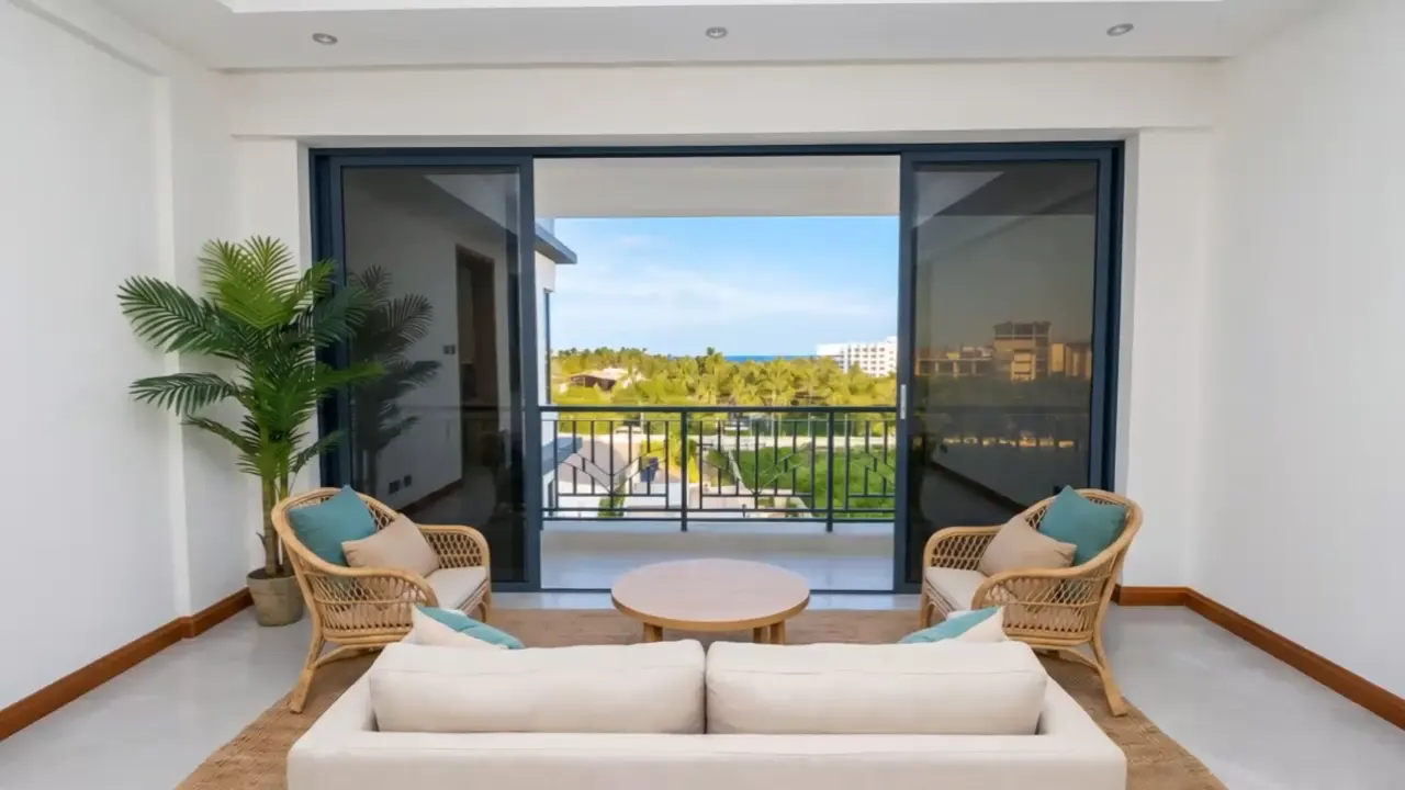 The furnished sitting room, gliding towards the balcony doors and the sea view